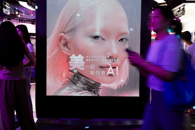 People walk past the L’Oreal booth during the World Artificial Intelligence Conference (WAIC) in Shanghai, China, July 17, 2026. REUTERS/Go Nakamura