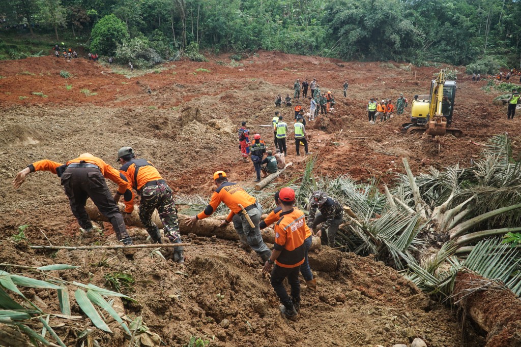 Photo by BAKHTIAR RAHMAN / AFP  Rescuers search for survivors after a landslide buried some houses in Cibeunying village, Cilacap regency, Central Java, on November 14, 2025.