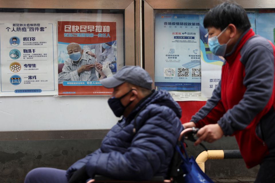 People pass by a poster encouraging elderly people to get vaccinated against the coronavirus disease. (Reuters) People pass by a poster encouraging elderly people to get vaccinated against the coronavirus disease. (Reuters)