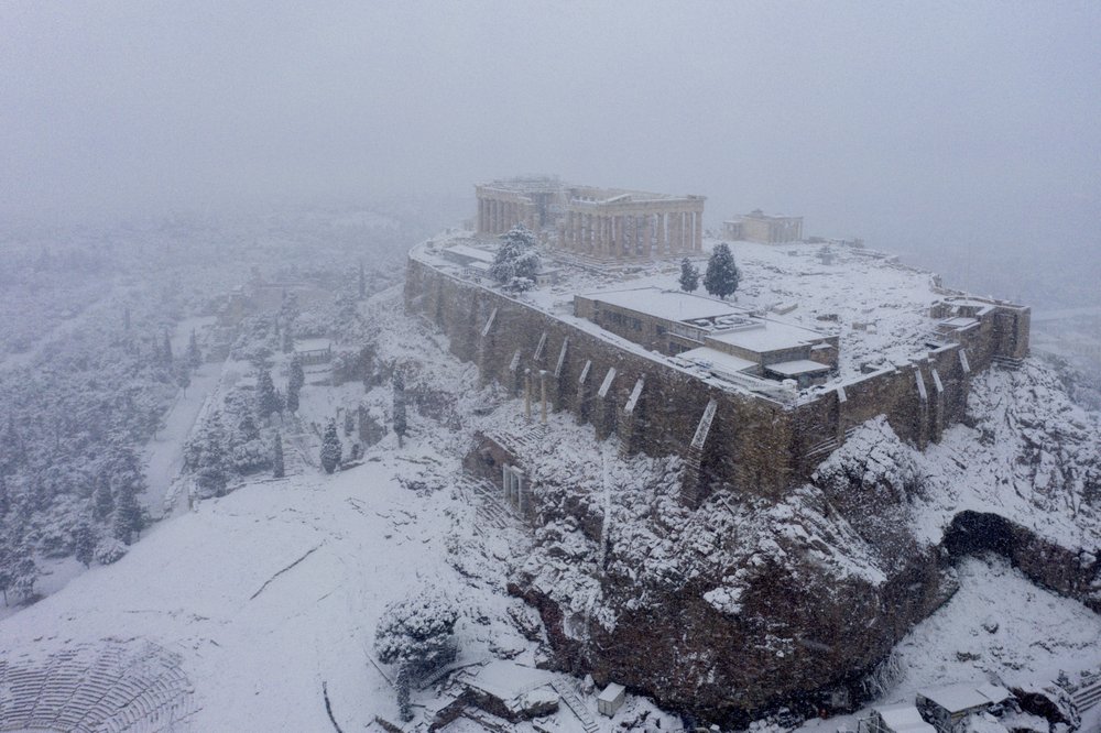 Snow covers the ancient Acropolis hill in Athens, Tuesday, February 16, 2021. Unusually heavy snowfall has blanketed central Athens.
