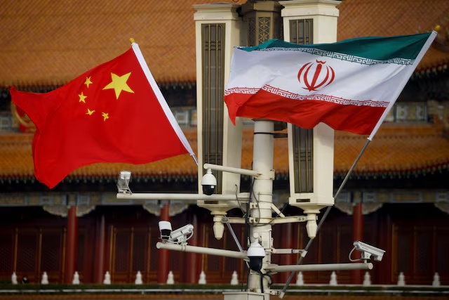 The national flags of China and Iran fly in Tiananmen Square, China, February 14, 2023. REUTERS/Thomas Peter/File Photo