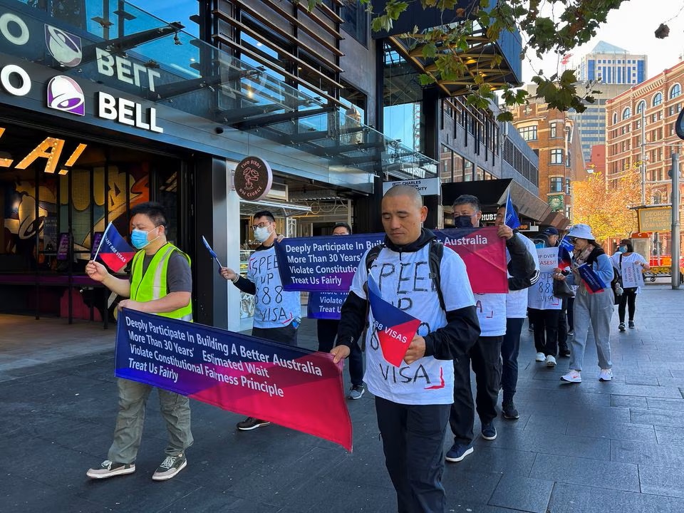 Chinese migrants protest against Australia's policy shift on the investment visa scheme, as they march outside the Australian Broadcasting Corporation office in Sydney. (Reuters) Chinese migrants protest against Australia's policy shift on the investment visa scheme, as they march outside the Australian Broadcasting Corporation office in Sydney. (Reuters)