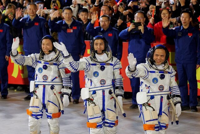 Astronauts Zhang Hongzhang, Wu Fei and Zhang Lu wave during a see-off ceremony before taking part in the Shenzhou-21 spaceflight mission to China's Tiangong space station, at Jiuquan Satellite Launch Center, near Jiuquan, Gansu province, China October 31, 2025. REUTERS/Maxim Shemetov/File Photo