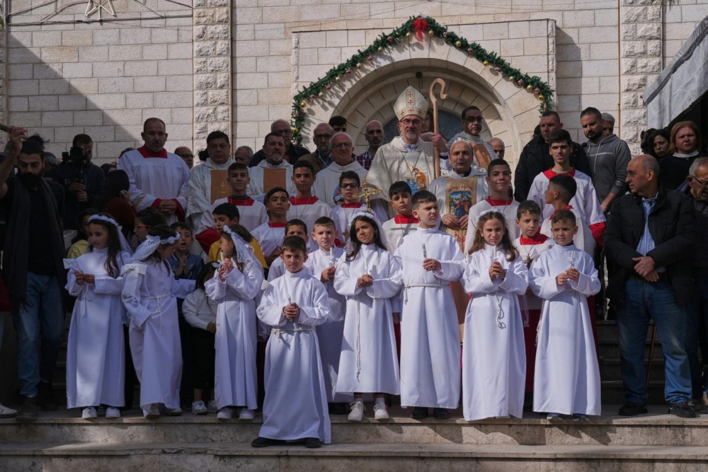 Cardinal Pierbattista Pizzaballa, the Latin Patriarch of Jerusalem, poses for the photos with Palestinian parishioners after leading a mass ahead of Christmas celebrations at the Holy Family Catholic Church in Gaza City, Sunday, Dec. 21, 2025. (AP Photo/Jehad Alshrafi)