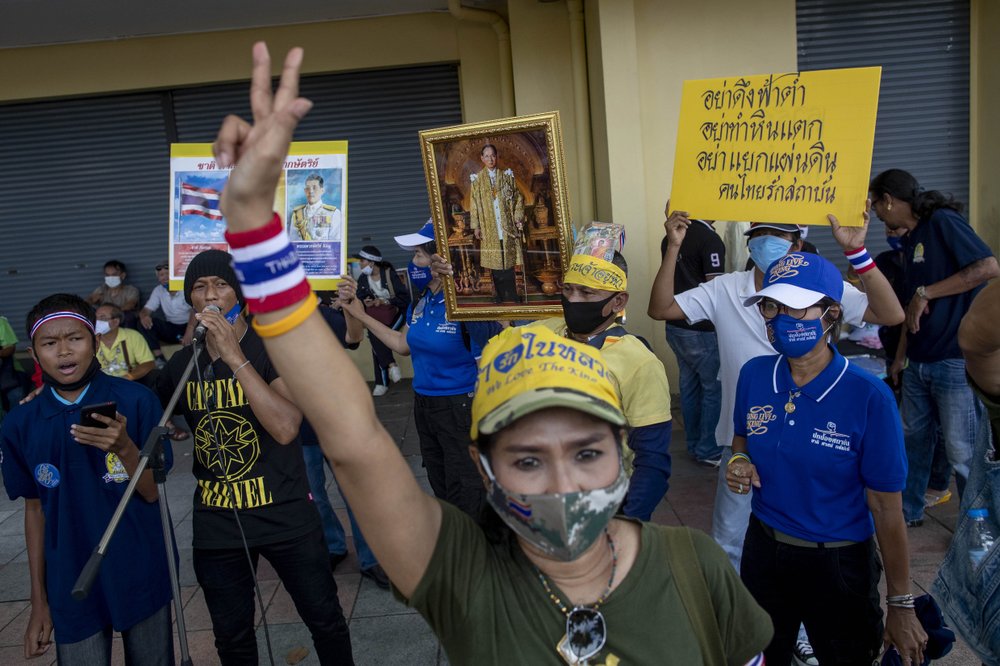 Supporters of the Thai monarchy display portrait of the late King Bhumibol Adulyadej near Democracy Monument where anti-government protesters are gathering Sunday.