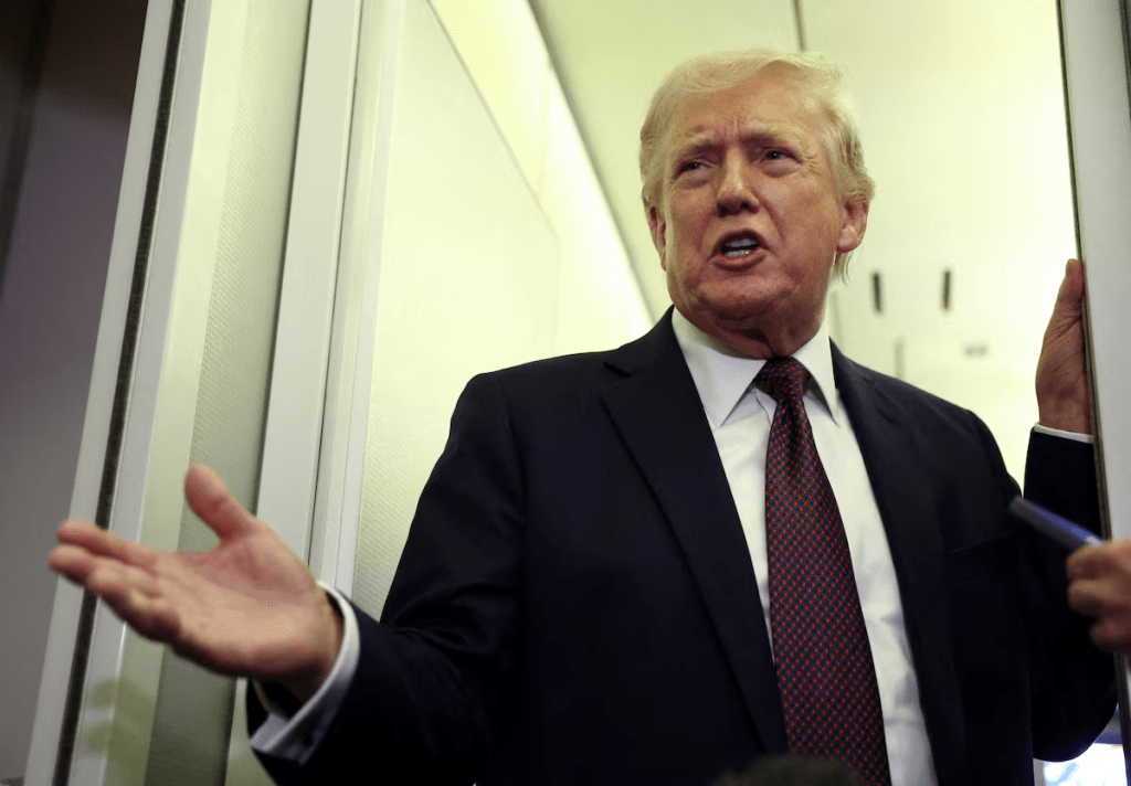 U.S. President Donald Trump speaks to reporters aboard Air Force One on a flight back to Washington March 15, 2026. REUTERS/Kevin Lamarque/File Photo