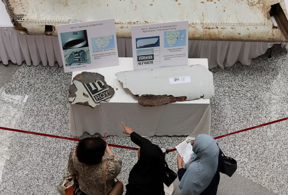 Visitors look at the wreckage believed to be from the missing Malaysia Airlines flight MH370 during a remembrance event marking the 10th anniversary of its disappearance, in Subang Jaya, Malaysia, March 3. REUTERS/Hasnoor Hussain