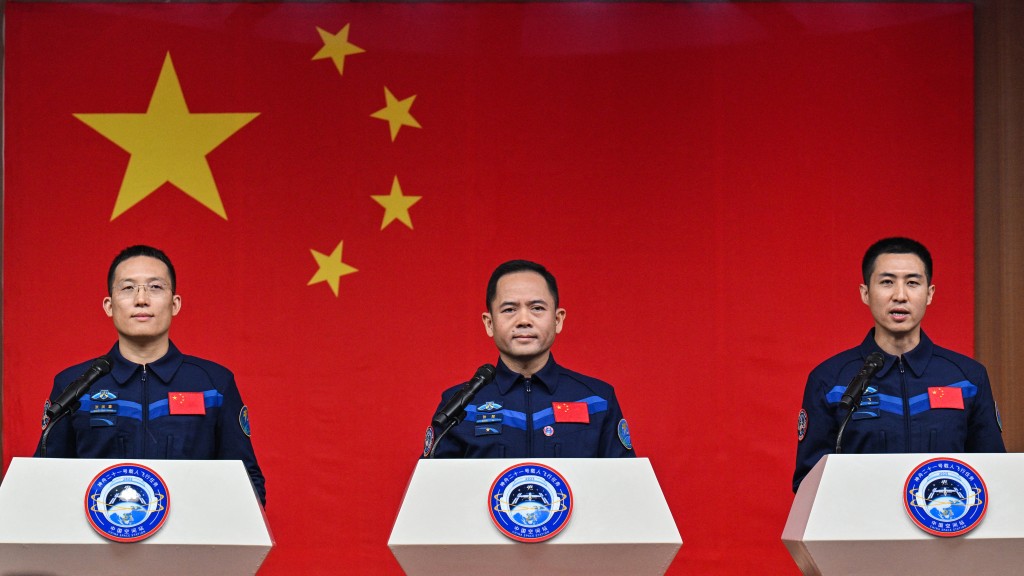 Astronauts for China's Shenzhou-21 space mission Zhang Hongzhang (L), Commander Zhang Lu (C) and Wu Fei (R) attend a press conference a day before the launch of the mission at the Jiuquan Satellite Launch Centre in the Gobi desert, in northwest China on October 30, 2025. (Photo by Hector RETAMAL / AFP)