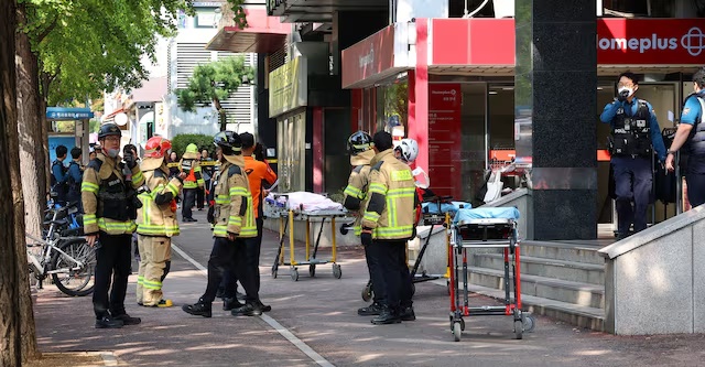 Firefighters and policemen gather outside the scene where several people were injured in a stabbing incident, in Incheon, South Korea, October 13, 2026. Yonhap via REUTERS