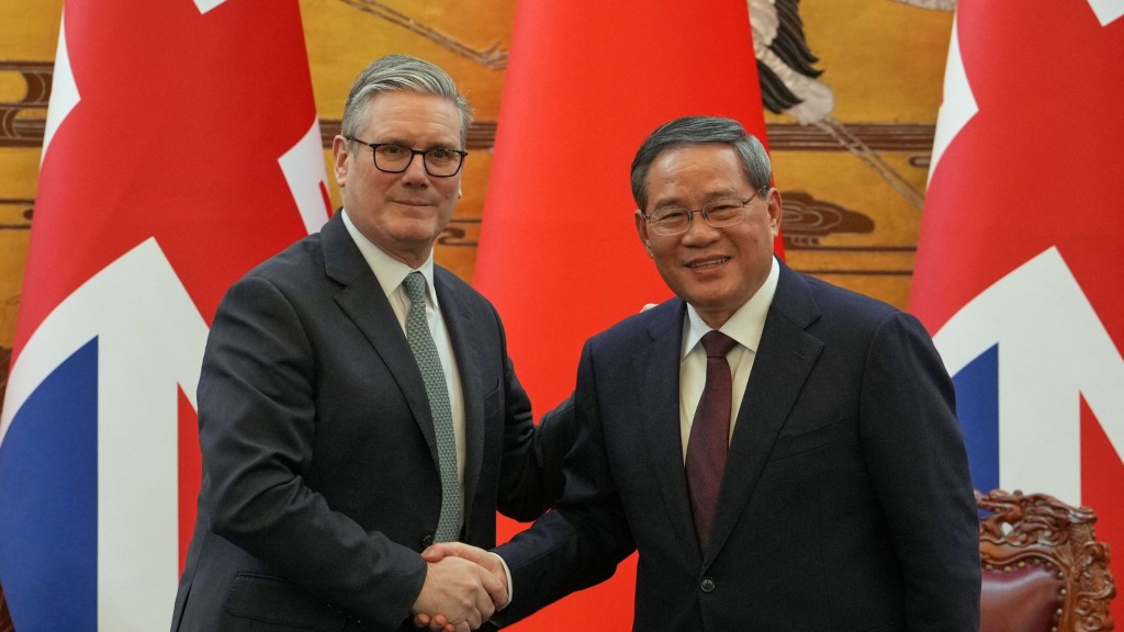Britain's PM Keir Starmer and Chinese Premier Li Qiang shake hands after a signing ceremony. Reuters