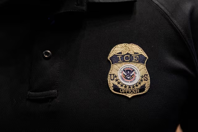 The badge of a U.S. Immigration and Customs Enforcement (ICE) is embroidered on a polo shirt of an ICE employee, at a U.S. Immigration and Customs Enforcement two-day job fair in Texas to help fill vacancies for deportation officers and attorneys, in Arlington, Texas, U.S. August 26, 2025. REUTERS/Shelby Tauber 