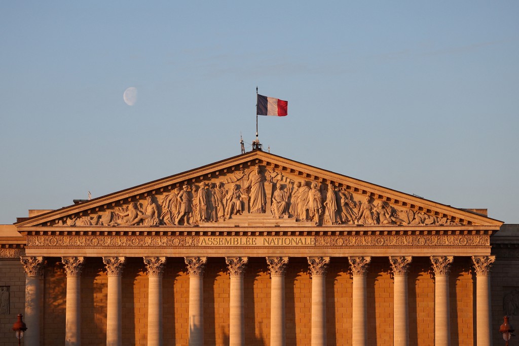 A French flag flies over the National Assembly in Paris, France, April 18, 2025. REUTERS/Abdul Saboor