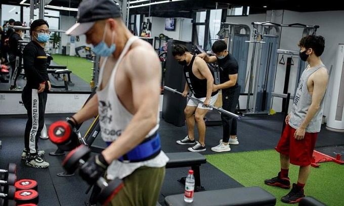 People exercise at a fitness club in Beijing, China, 2020. Photo by Reuters People exercise at a fitness club in Beijing, China, 2020. Photo by Reuters