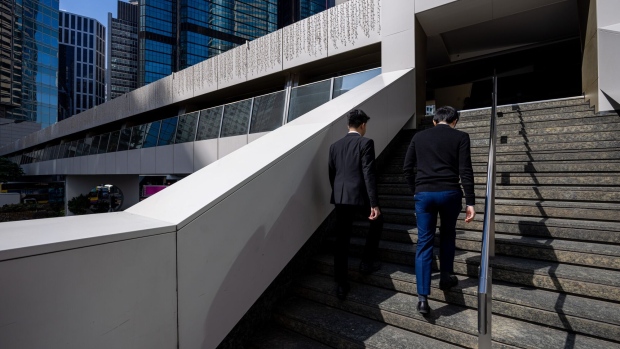 Office workers climb steps in the Central district in Hong Kong. (Bloomberg) Office workers climb steps in the Central district in Hong Kong. (Bloomberg)