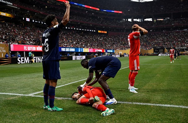 Soccer Football - FIFA Club World Cup - Quarter Final - Paris St Germain v Bayern Munich - Mercedes-Benz Stadium, Atlanta, Georgia, U.S. - July 5, 2025 Bayern Munich's Jamal Musiala sustains an injury after a collision with Paris St Germain's Gianluigi Donnarumma REUTERS/Pablo Morano/File Photo
