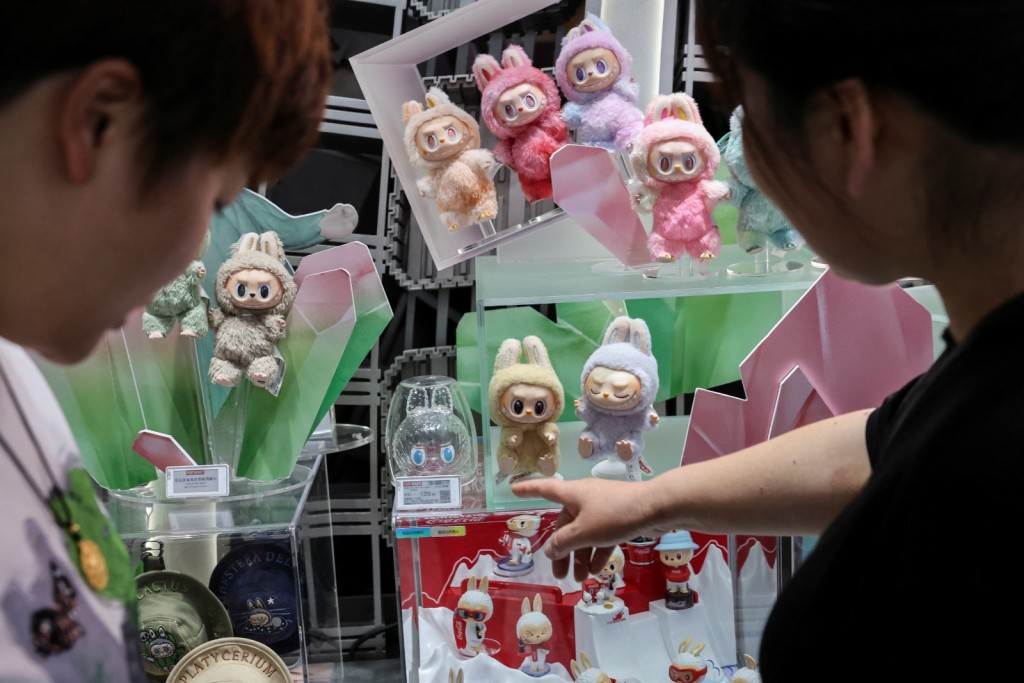 People look at Labubu dolls at the flagship store of Pop Mart in Shanghai, China. REUTERS/Go Nakamura
