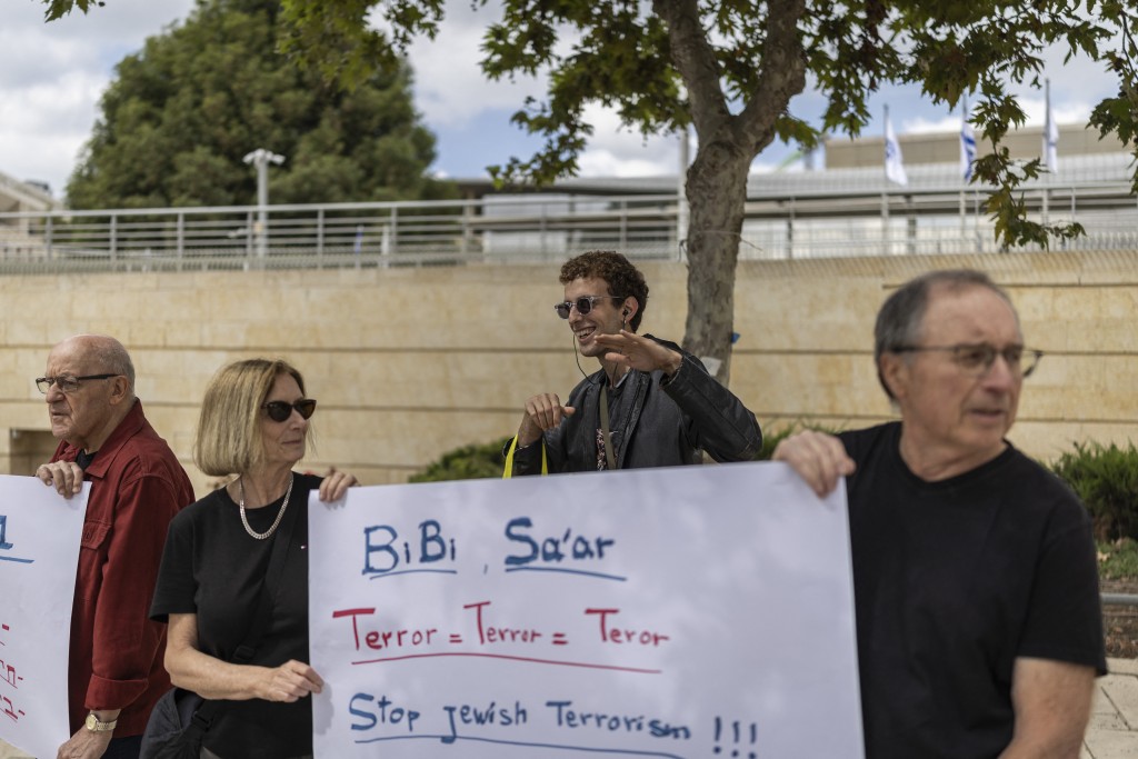 Former Israeli ambassadors and employees of the Foreign Ministry hold placards during a demonstration against settler violence in the West Bank, outside the Foreign Ministry in Jerusalem on October 18, 2026.