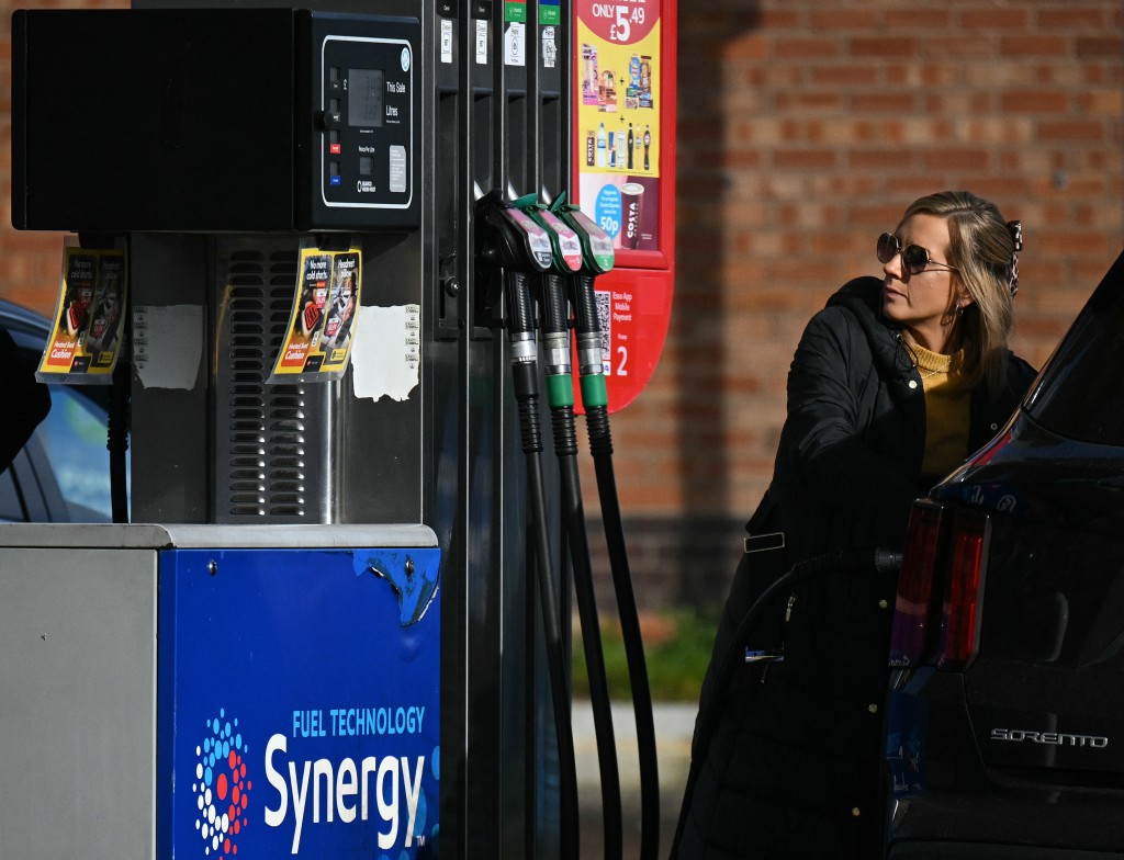 Photo by OLI SCARFF / AFP  A motorist refuels a vehicle with diesel fuel at an Esso petrol station in Lutterworth, near Rugby in central England, on March 10, 2026.
