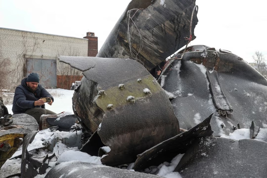 A man photographs parts of an unidentified missile, which Ukrainian authorities believe to be made in North Korea and was used in a strike in Kharkiv earlier this week, amid Russia's attack on Ukraine, in Kharkiv, Ukraine January 6, 2024. REUTERS/Vyacheslav Madiyevskyy/File Photo