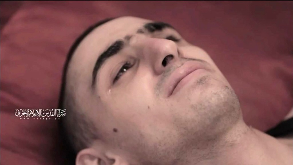 This screengrab from a video released on July 31 by Al-Quds Brigades, the armed wing of Palestinian militant group Islamic Jihad shows a hostage, identified as Rom Braslavski by the Hostages and Missing Families Forum(Photo by Islamic Jihad Media Office / AFP)