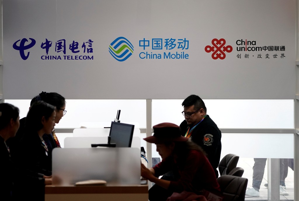Signs of China Telecom, China Mobile and China Unicom are seen during the China International Import Expo (CIIE) at the National Exhibition and Convention Center in Shanghai, China, Nov. 5, 2018. REUTERS/Aly Song