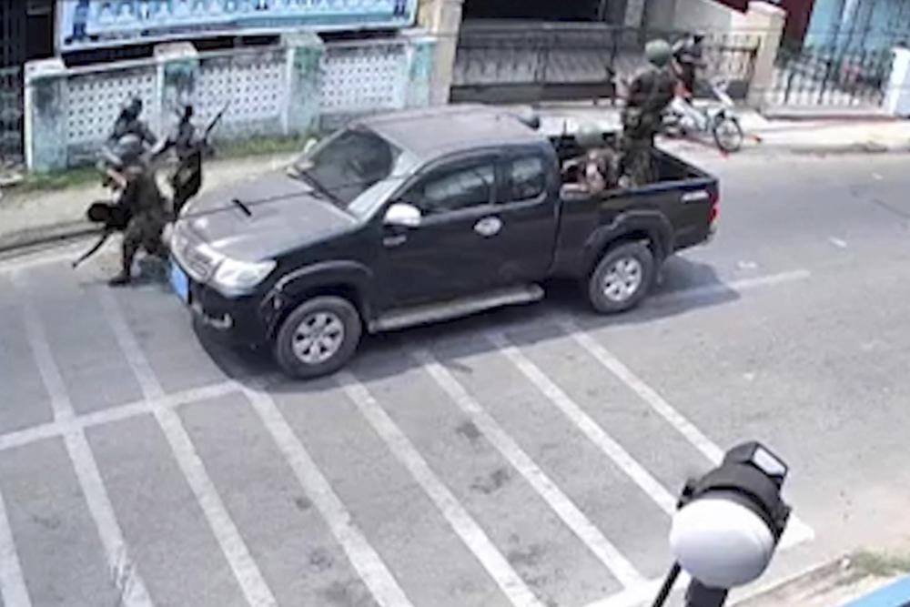 In this March 27, 2021 image from video obtained by The Associated Press, 17-year old Kyaw Min Latt is carried by security forces after a soldier aimed, then fired his rifle towards him and two companions who were riding a motorbike in Dawei, Myanmar. The teenager later died, and his father said army doctors wanted to perform an autopsy. The family fought against it but said the hospital would not release the body until they agreed to sign a paper saying Kyaw Min Latt’s death was caused by head injuries sustained after falling from the motorbike.