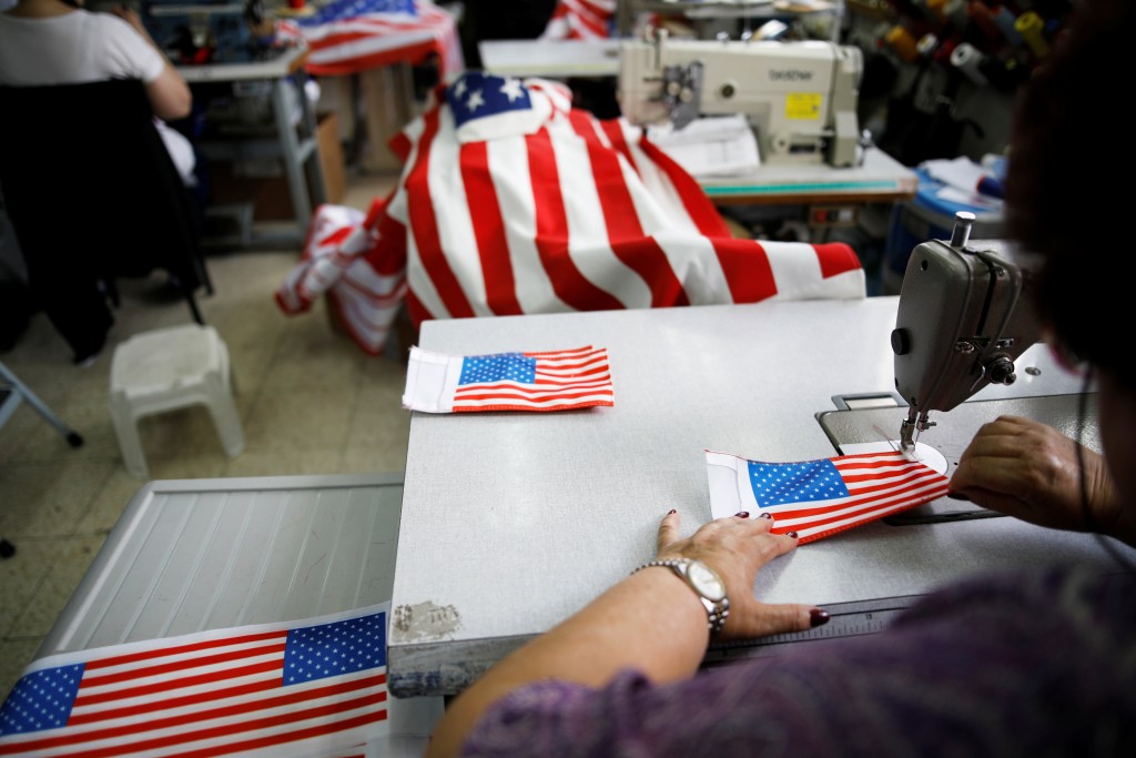 An employee works at a workshop manufacturing U.S. flags in preparation for U.S. President Donald Trump's visit, in Kfar Saba, Israel May 21, 2017. REUTERS