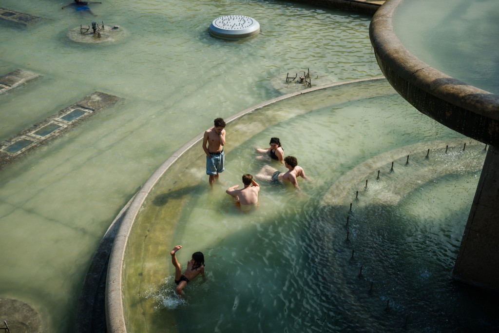 People cool off in the Trocadero Fountain, in front of the Eiffel Tower in Paris, on July 2, 2025. (AFP)