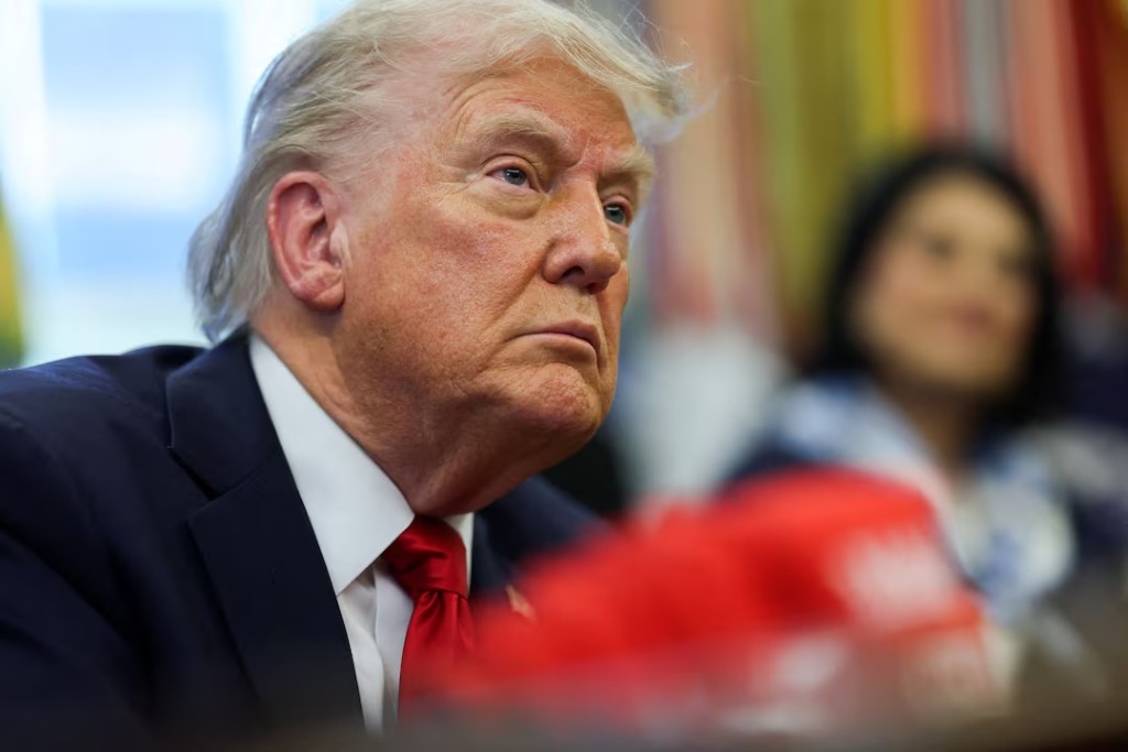 U.S. President Donald Trump looks on, as he signs executive orders in the Oval Office at the White House in Washington, D.C., U.S., April 23, 2025. REUTERS/Leah Millis/File Photo