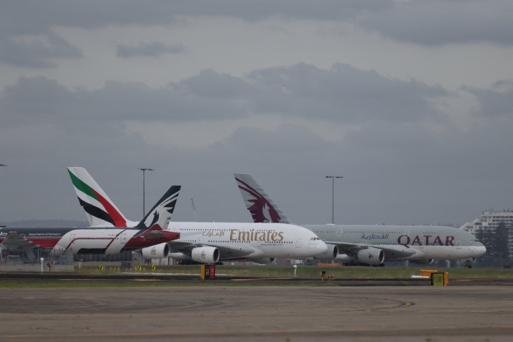 Emirates and Qatar Airways planes sit on the tarmac at Sydney Kingsford Smith Airport in Sydney, Australia, March 3, 2026. (Reuters)