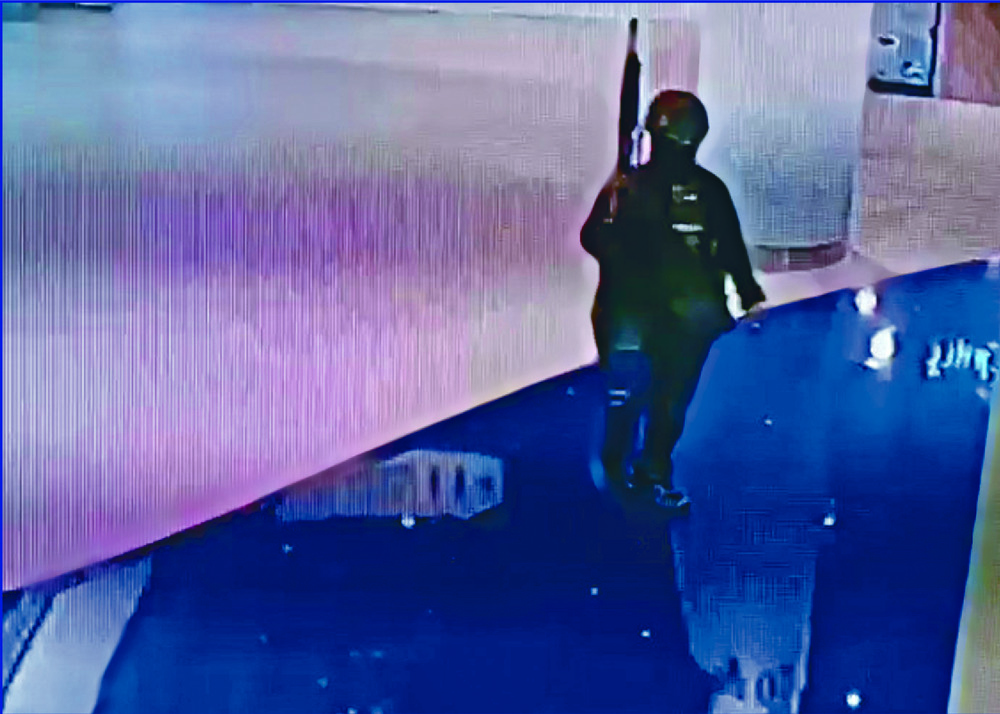 Jakrapanth Thomma, who posted Facebook updates during the bloody spree, roams the mall in a video grab before commando soldiers storm in. REUTERS