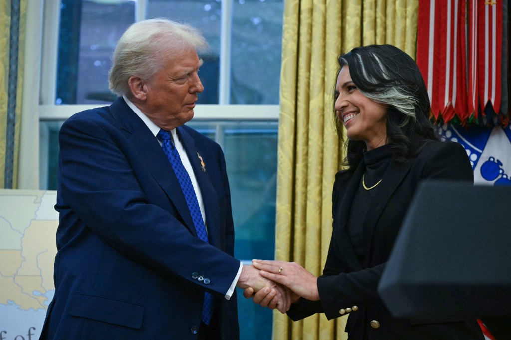 Photo by ANDREW CABALLERO-REYNOLDS / AFP US President Donald Trump shakes hands with Tulsi Gabbard after she was sworn in as Director of National Intelligence (DNI) in the Oval Office of the White House in Washington, DC, on February 12, 2025.