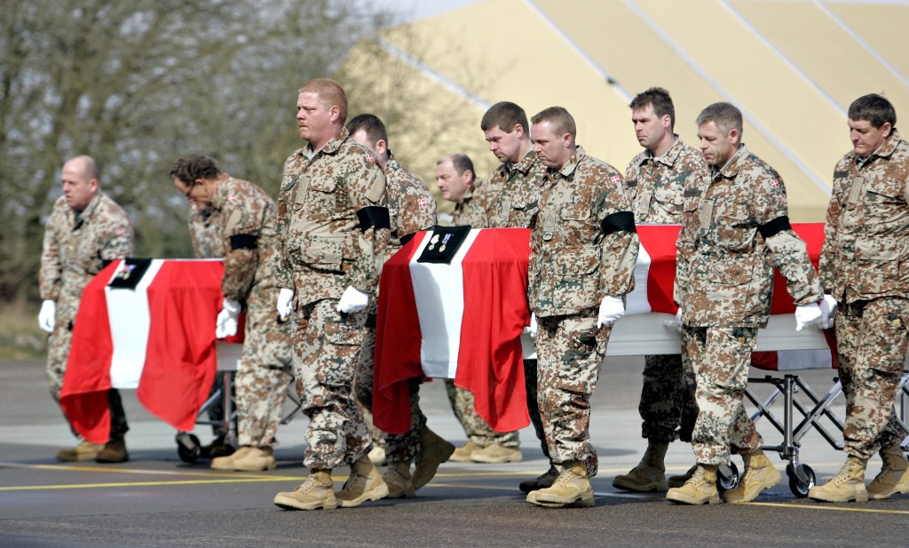 Photo by CLAUS FISKER / SCANPIX DENMARK / AFP  The coffins of two Danish soldiers killed in a suicide attack in Gereshk, Afghanistan, last week, are carried out of a military tranport plane upon its arrival at the Skrydstrup Airport in Jutland, Denmark on March 23, 2008.