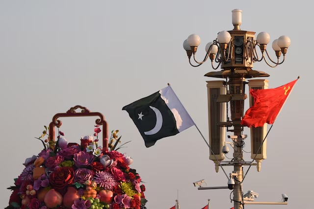 Pakistani and Chinese national flags flutter next to an installation featuring a giant flower basket at the Tiananmen Square in Beijing, China October 7, 2019. Picture taken October 7, 2019. REUTERS/Stringer ATTENTION EDITORS - THIS IMAGE WAS PROVIDED BY A THIRD PARTY. CHINA OUT. 