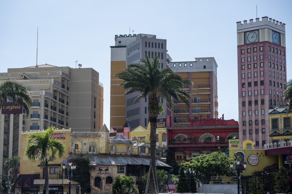 Photo by ANDREW CABALLERO-REYNOLDS / AFP Hotels and an American themed mall are seen at the Mihama American Village in Okinawa prefecture on October 10, 2026.