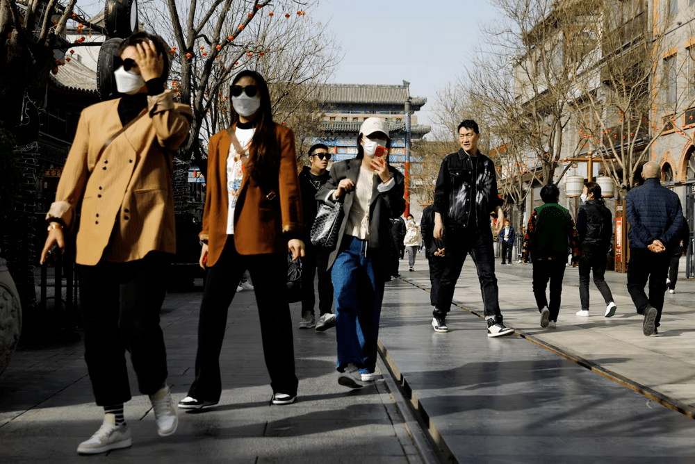 People walk at the tourism site of Qianmen street, in Beijing, China March 14, 2023. REUTERS/Tingshu Wang/File Photo People walk at the tourism site of Qianmen street, in Beijing, China March 14, 2023. REUTERS/Tingshu Wang/File Photo