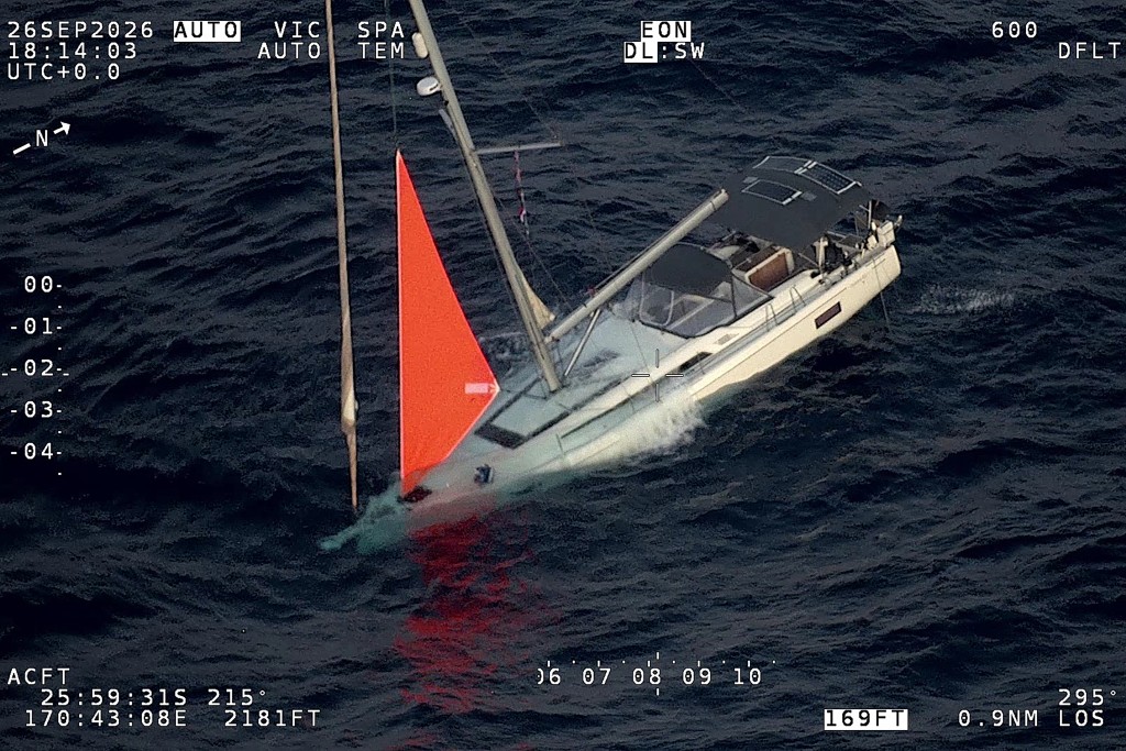 Photo by HANDOUT / NEW ZEALAND DEFENCE FORCE / AFP  This handout image taken on September 26, 2026 and released by the New Zealand Defence Force on October 1, 2026 shows a yacht sinking after a sperm whale struck and cracked the hull in the remote South Pacific.