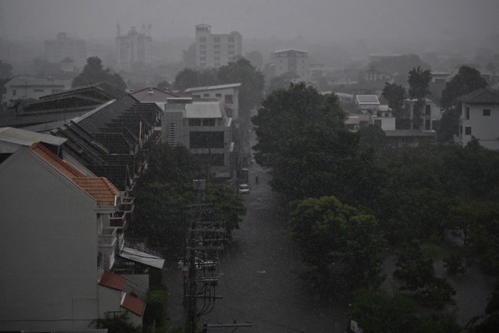 A resident navigates a flooded street during heavy rain in Bang Kapi district in Bangkok on September 28, 2026. (AFP)
