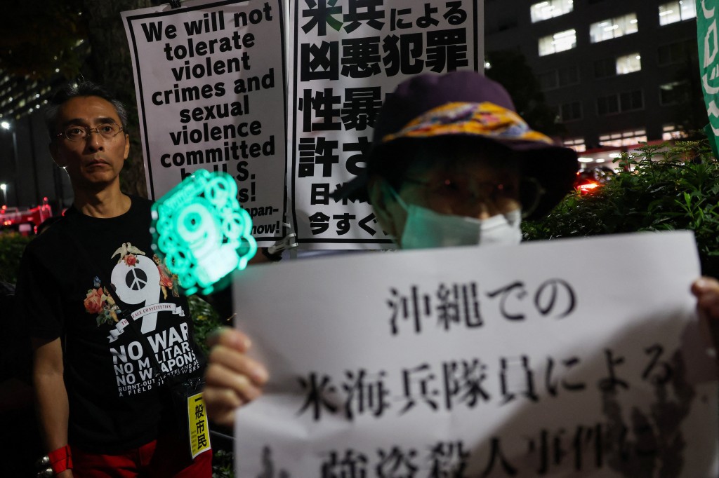 Protest outside Foreign Ministry building following the killing of a Japanese woman in Okinawa, in Tokyo (REUTERS)