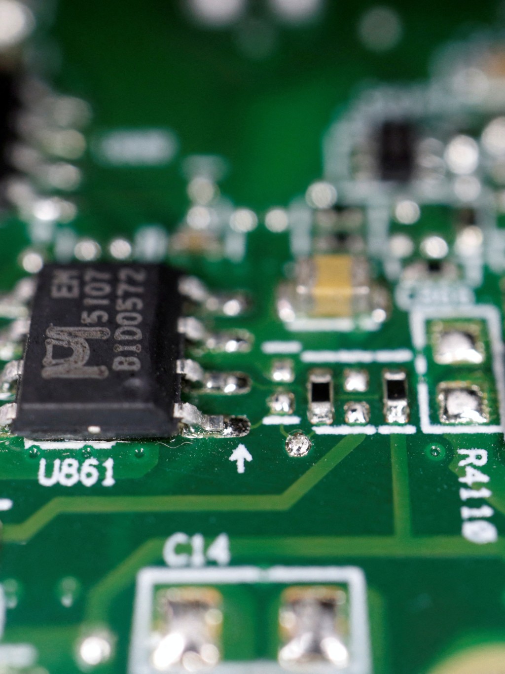 Semiconductor chips are seen on a printed circuit board in this illustration picture taken February 17, 2023. REUTERS/Florence Lo