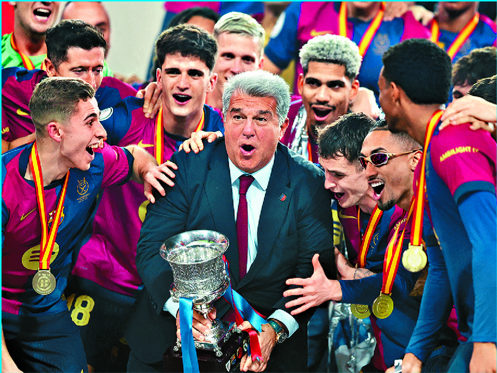 Barcelona president Joan Laporta lifts the trophy. AFP Barcelona president Joan Laporta lifts the trophy. AFP