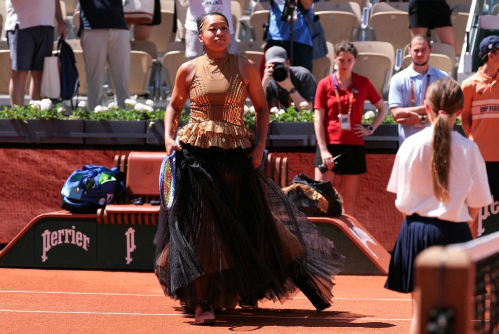 Naomi Osaka entered the court in a Kevin Germanier skirt before unveiling her Nike match dress. AFP