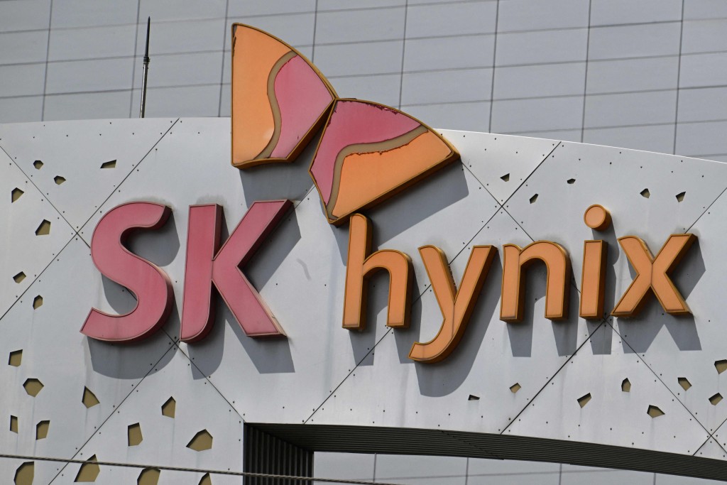 The logo of SK hynix is seen on the main gate of the company's headquarters in Icheon on July 29, 2026. South Korea's SK hynix said on July 29 second-quarter net profit soared a whopping 1,242 percent year-on-year, driven by the artificial intelligence industry's explosive demand for its advanced memory chips. (Photo by Jung Yeon-je / AFP)