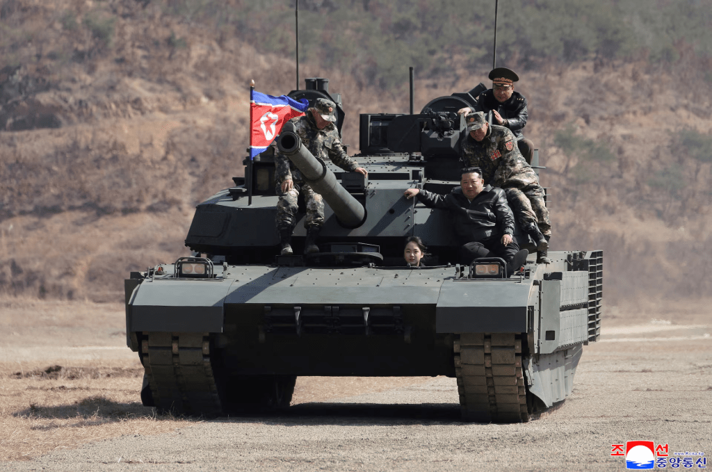 North Korean leader Kim Jong Un and his daughter Kim Ju Ae ride a tank during what North Korean state news agency KCNA reports is an offensive tactical drill involving a new type of tank, at a training base in Pyongyang, North Korea, March 19, 2026, in this picture released by North Korea's official Korean Central News Agency. KCNA via REUTERS 