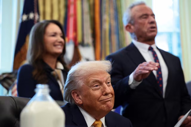 U.S. President Donald Trump listens as U.S. Health and Human Services (HHS) Secretary Robert F. Kennedy Jr. speaks during the signing ceremony for the Whole Milk for Healthy Kids Act in the Oval Office at the White House in Washington, D.C., U.S., January 14, 2026. REUTERS/Evelyn Hockstein 