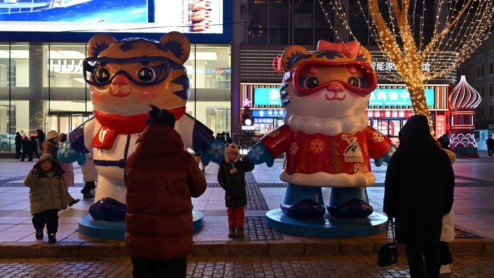 People have their pictures taken with mascots of the Asian Winter Games in Harbin © ADEK BERRY / AFP People have their pictures taken with mascots of the Asian Winter Games in Harbin © ADEK BERRY / AFP