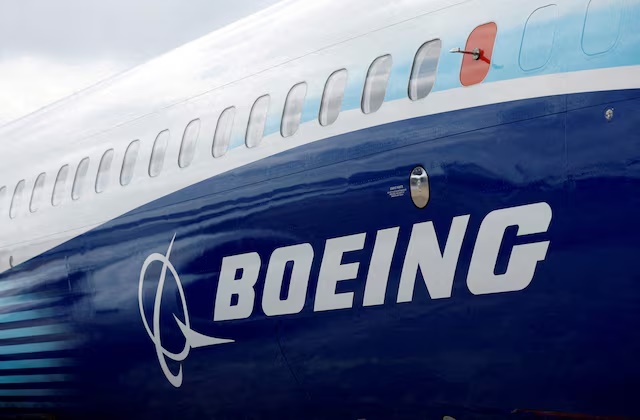 The Boeing logo is seen on the side of a Boeing 737 MAX at the Farnborough International Airshow, in Farnborough, Britain, July 20, 2022. REUTERS/Peter Cziborra/File Photo