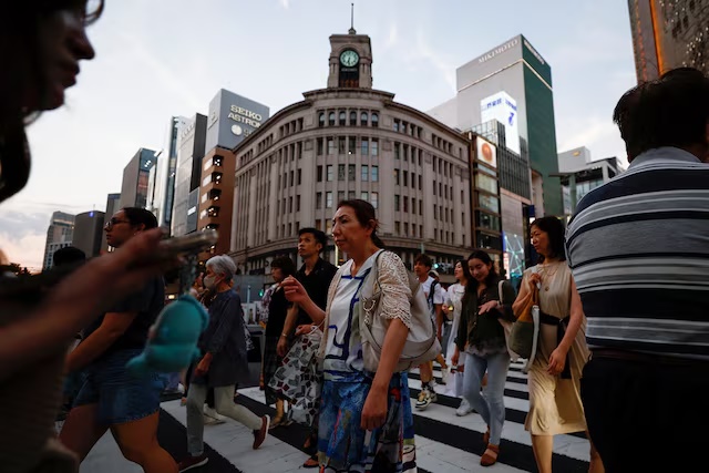 People cross the street at Ginza shopping district in Tokyo, Japan, August 11, 2024. REUTERS/Willy Kurniawan/File Photo