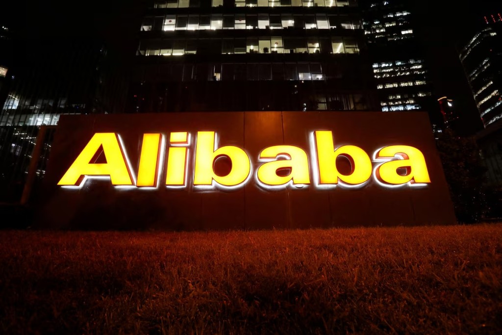 The logo of Alibaba Group is lit up at its office building in Beijing, China.  REUTERS