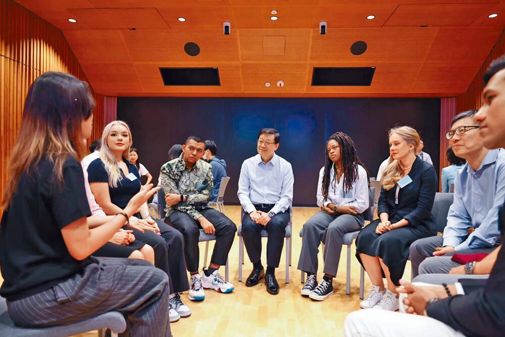 John Lee is briefed on University of Science and Technology building progress and, right, listens to students. John Lee is briefed on University of Science and Technology building progress and, right, listens to students.